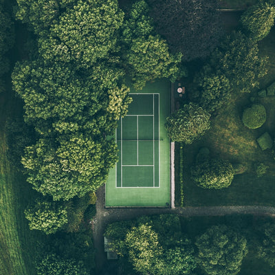 green sustainable tennis court in the trees