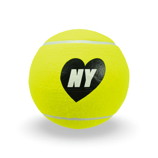 Yellow tennis ball with a black heart and 'NY' text on a light gray background