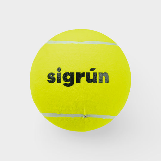 Yellow tennis ball with 'sigrön' branding on a light gray background